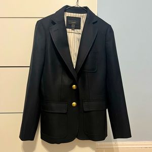 Black blazer with red and white lining and gold buttons